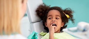 Child pointing to her tooth