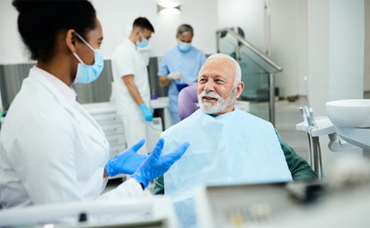 : a dentist explaining to a patient about dentures in Carlisle
