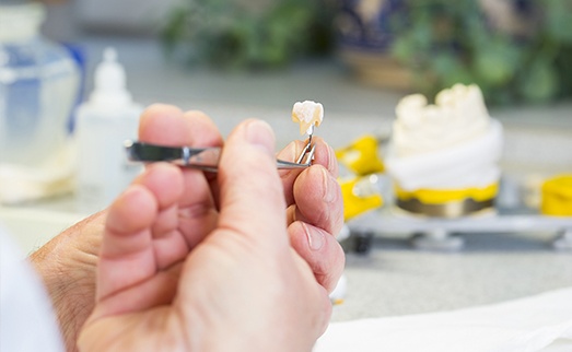 Dental lab technician crafting custom dental restoration