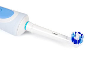 white and blue electric toothbrush